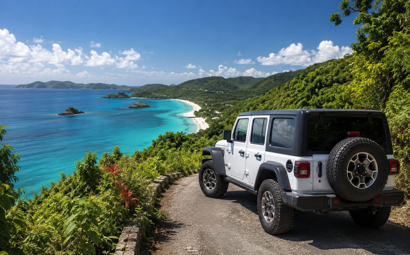 A Jeep on a coastal road above a turquoise bay on St. John
